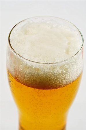 simsearch:400-04083275,k - Glass of beer closeup on a white background Stock Photo - Budget Royalty-Free & Subscription, Code: 400-04883565