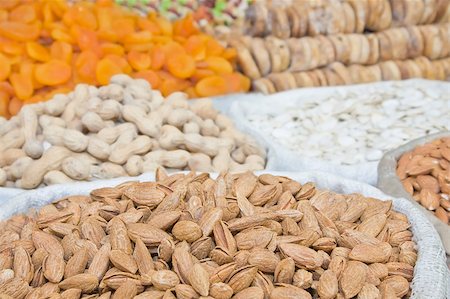 simsearch:400-04833195,k - Natural unprocessed almonds in focus on foreground with unfocused nuts and dried fruits on backround Stock Photo - Budget Royalty-Free & Subscription, Code: 400-04896123