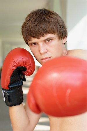 student fighting - Close-up portrait of a young boxer with red gloves Stock Photo - Budget Royalty-Free & Subscription, Code: 400-04896665