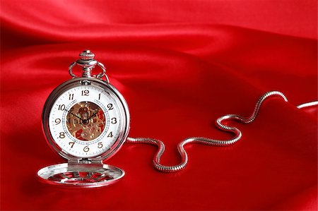 pocket watch - White pocket watch with open lid on red silk background Stock Photo - Budget Royalty-Free & Subscription, Code: 400-04896684