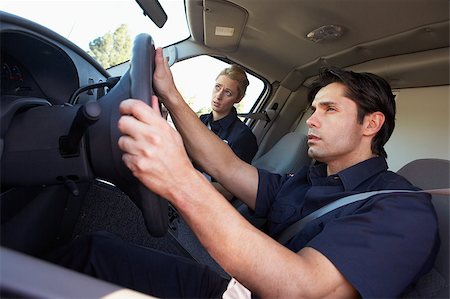 simsearch:400-05343071,k - Ambulance driver and colleague on the way to an emergency Stock Photo - Budget Royalty-Free & Subscription, Code: 400-04890145