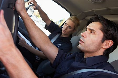 simsearch:400-05343071,k - Ambulance driver and colleague on the way to an emergency Stock Photo - Budget Royalty-Free & Subscription, Code: 400-04890146