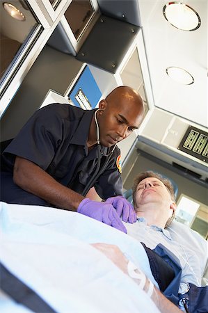 simsearch:400-05343071,k - Paramedic attending to patient in ambulance Stock Photo - Budget Royalty-Free & Subscription, Code: 400-04890156
