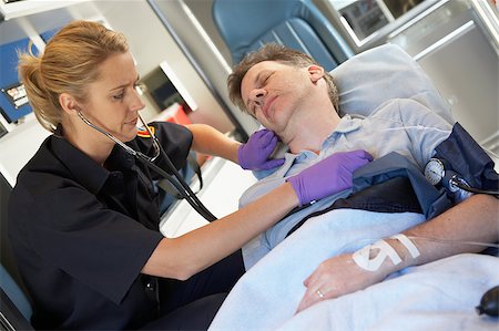 simsearch:400-05343071,k - Paramedic attending to patient in ambulance Stock Photo - Budget Royalty-Free & Subscription, Code: 400-04890157