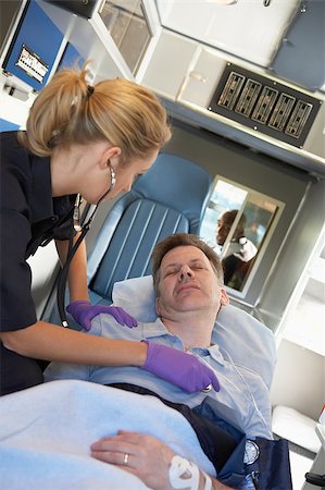 simsearch:400-05343071,k - Paramedic attending to patient in ambulance Stock Photo - Budget Royalty-Free & Subscription, Code: 400-04890159