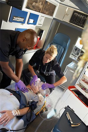 simsearch:400-05343071,k - Paramedics performing CPR on patient in ambulance Stock Photo - Budget Royalty-Free & Subscription, Code: 400-04890153