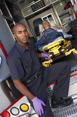 simsearch:400-05343071,k - Male paramedic preparing to unload patient from ambulance Stock Photo - Budget Royalty-Free & Subscription, Code: 400-04890172