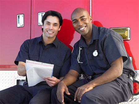simsearch:400-05343071,k - Two paramedics cheerfully doing paperwork, sitting by their ambu Stock Photo - Budget Royalty-Free & Subscription, Code: 400-04890216