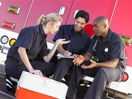 simsearch:400-05343071,k - Three paramedics chatting and doing paperwork, sitting by their Stock Photo - Budget Royalty-Free & Subscription, Code: 400-04890217