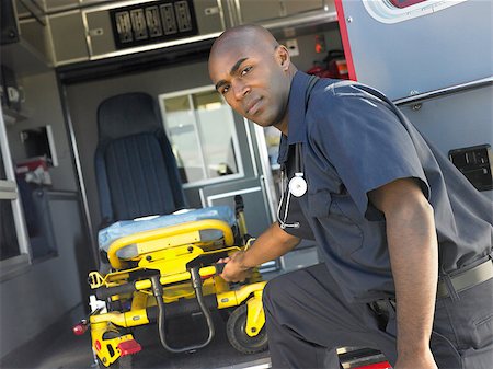 simsearch:400-05343071,k - Paramedic removing empty gurney from ambulance Stock Photo - Budget Royalty-Free & Subscription, Code: 400-04890219