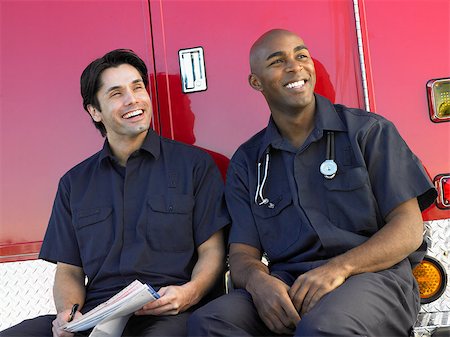 simsearch:400-05343071,k - Two paramedics cheerfully doing paperwork, sitting by their ambu Stock Photo - Budget Royalty-Free & Subscription, Code: 400-04890213
