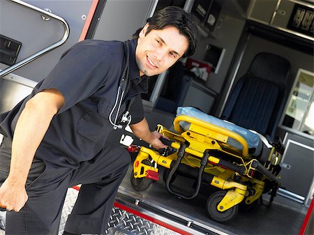 simsearch:400-05343071,k - Paramedic removing empty gurney from ambulance Stock Photo - Budget Royalty-Free & Subscription, Code: 400-04890225
