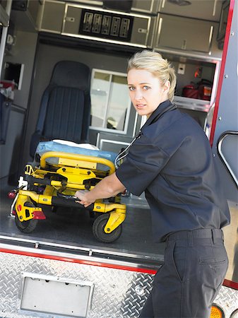 simsearch:400-05343071,k - Paramedic removing empty gurney from ambulance Stock Photo - Budget Royalty-Free & Subscription, Code: 400-04890222