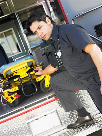 simsearch:400-05343071,k - Paramedic removing empty gurney from ambulance Stock Photo - Budget Royalty-Free & Subscription, Code: 400-04890223