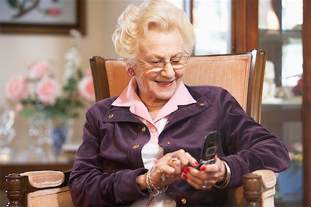 phone one person adult smile elderly - Senior woman text messaging Stock Photo - Budget Royalty-Free & Subscription, Code: 400-04890257