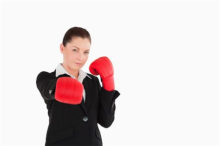 space suit model - Good looking woman wearing some boxing gloves while standing against a white background Foto de stock - Super Valor sin royalties y Suscripción, Código: 400-04890621