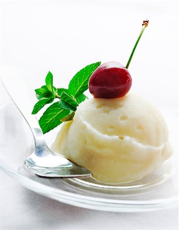 simsearch:400-05718903,k - Vanilla ice cream decorated with fresh mint and cherry Stock Photo - Budget Royalty-Free & Subscription, Code: 400-04893415