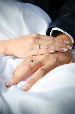 Newlyweds holding hands, their wedding bands showing Photographie de stock - Aubaine LD & Abonnement, Code: 400-04893718