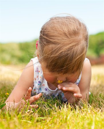 simsearch:400-04416781,k - Little girl olfact flower and lying on grass in the park Stock Photo - Budget Royalty-Free & Subscription, Code: 400-04893846