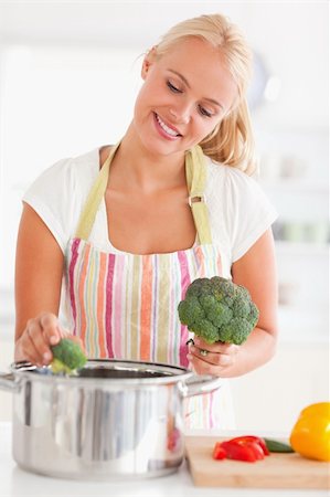 simsearch:400-05740111,k - Portrait of a cute woman putting cabbage on water while wearing an apron Stock Photo - Budget Royalty-Free & Subscription, Code: 400-04904426