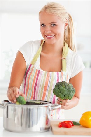 simsearch:400-05740111,k - Portrait of a smiling woman putting cabbage on water while looking at the camera Stock Photo - Budget Royalty-Free & Subscription, Code: 400-04904427