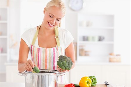 simsearch:400-05740111,k - Woman putting cabbage on boiling water while wearing an apron Stock Photo - Budget Royalty-Free & Subscription, Code: 400-04904420