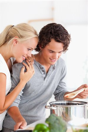 simsearch:400-05740111,k - Portrait of a couple tasting a meal in their kitchen Stock Photo - Budget Royalty-Free & Subscription, Code: 400-04904494