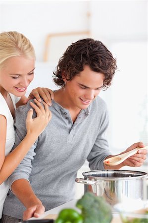simsearch:400-05740111,k - Close up of a couple tasting a meal in their kitchen Stock Photo - Budget Royalty-Free & Subscription, Code: 400-04904493