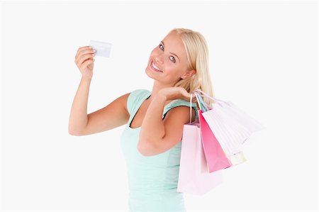 simsearch:400-04904785,k - Smiling woman with a credit card and bags in a studio Stock Photo - Budget Royalty-Free & Subscription, Code: 400-04904776