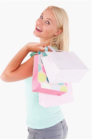 simsearch:400-04904785,k - Joyful blond woman with shopping bags in a studio Stock Photo - Budget Royalty-Free & Subscription, Code: 400-04904771
