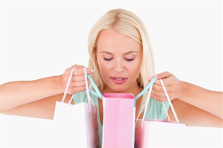 simsearch:400-04904785,k - Joyful blond woman looking into her bags in a studio Stock Photo - Budget Royalty-Free & Subscription, Code: 400-04904780