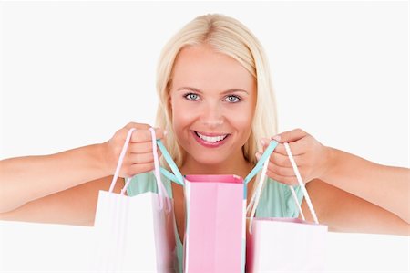 simsearch:400-04904785,k - Happy woman with bags looking into the camera in a studio Stock Photo - Budget Royalty-Free & Subscription, Code: 400-04904781
