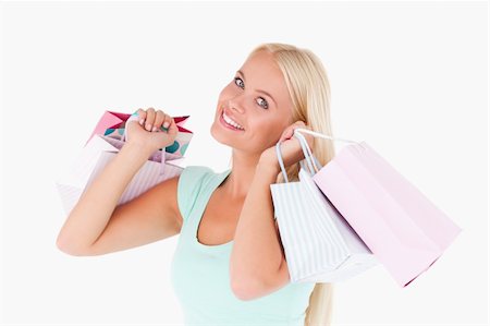 simsearch:400-04904785,k - Happy woman holding shopping bags in a studio Stock Photo - Budget Royalty-Free & Subscription, Code: 400-04904782