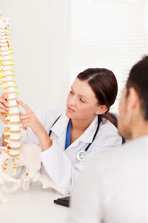 A doctor is pointing on a bone in a spine Stock Photo - Budget Royalty-Free & Subscription, Code: 400-04905108