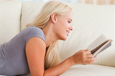 simsearch:400-04418460,k - Cute woman reading a book in her living room Stock Photo - Budget Royalty-Free & Subscription, Code: 400-04905601