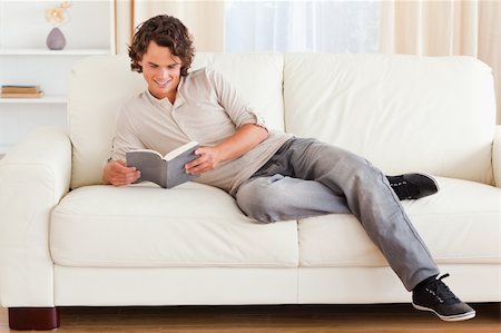 simsearch:400-04418460,k - Man reading a book in his living room Stock Photo - Budget Royalty-Free & Subscription, Code: 400-04905651