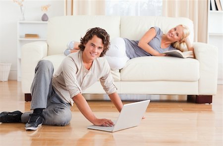 face to internet technology - Man with a notebook while his girlfriend is with a book looking at the camera Stock Photo - Budget Royalty-Free & Subscription, Code: 400-04905662