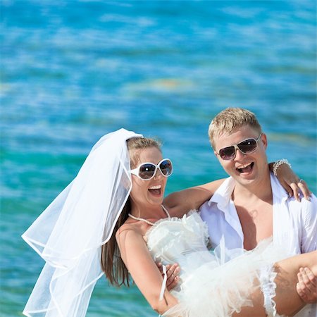 simsearch:400-05328142,k - Groom holding up a bride on the beach Stock Photo - Budget Royalty-Free & Subscription, Code: 400-04907285