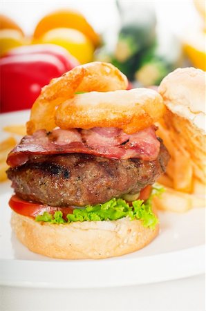 simsearch:400-06090558,k - classic american hamburger sandwich with onion rings and french fries,with fresh vegetables on background, MORE DELICIOUS FOOD ON PORTFOLIO Stock Photo - Budget Royalty-Free & Subscription, Code: 400-04908234