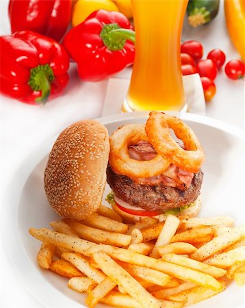 simsearch:400-06090558,k - classic american hamburger sandwich with onion rings and french fries,glass of  beer and fresh vegetables on background,  MORE DELICIOUS FOOD ON PORTFOLIO Stock Photo - Budget Royalty-Free & Subscription, Code: 400-04908235