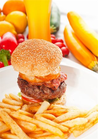 simsearch:400-06090558,k - classic american hamburger sandwich with onion rings and french fries,glass of  beer and fresh vegetables on background,  MORE DELICIOUS FOOD ON PORTFOLIO Stock Photo - Budget Royalty-Free & Subscription, Code: 400-04908237