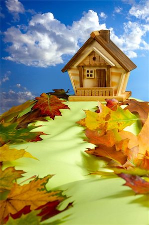 simsearch:400-04909150,k - Wooden house on a hill covered with fallen autumn leaves under blue cloudy sky Stock Photo - Budget Royalty-Free & Subscription, Code: 400-04909163