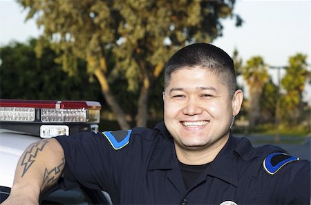 filipino (male) - a smiling police officer standing next to his patrol car. Stock Photo - Budget Royalty-Free & Subscription, Code: 400-04909741