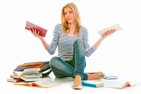 Confused teenager sitting on floor among schoolbooks isolated on white Stock Photo - Budget Royalty-Free & Subscription, Code: 400-04909943