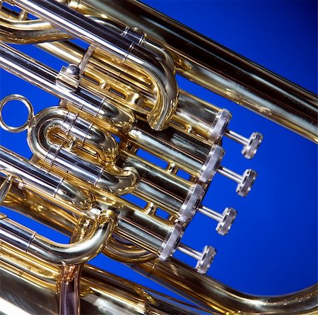 A gold brass tuba euphonium isolated against a blue background in the square format with copy space. Stock Photo - Budget Royalty-Free & Subscription, Code: 400-04900417