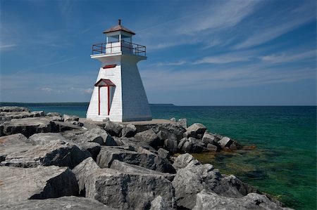 simsearch:400-04272525,k - A small lighthouse warns of a rough shoreline. Stock Photo - Budget Royalty-Free & Subscription, Code: 400-04900592