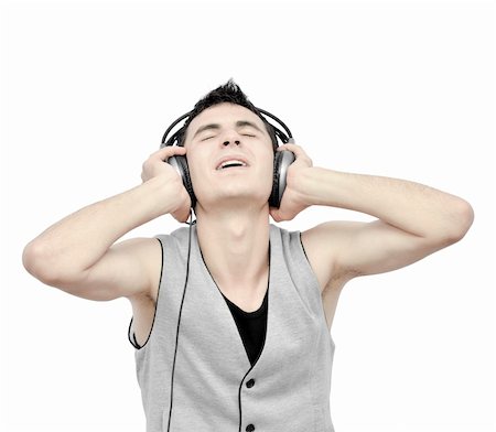 simsearch:400-04300097,k - Teenager listening music on headphones isolated on white background:NOTE:Grain was added.Strong contrast photography Stock Photo - Budget Royalty-Free & Subscription, Code: 400-04900759