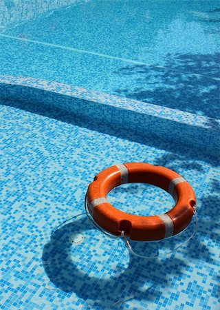 Life saver buoy ring floating in turquoise swimming pool Stock Photo - Budget Royalty-Free & Subscription, Code: 400-04903194