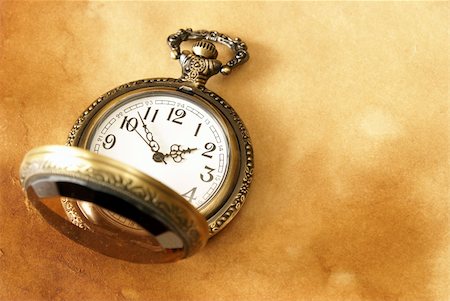 pocket watch - A macro shot of a pocket watch on some aged paper background. Stock Photo - Budget Royalty-Free & Subscription, Code: 400-04914724