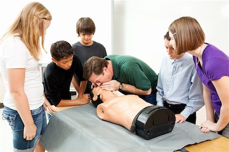 simsearch:400-07411030,k - High school health class instructor demonstrates CPR lifesaving techniques for his students. Stock Photo - Budget Royalty-Free & Subscription, Code: 400-04915687